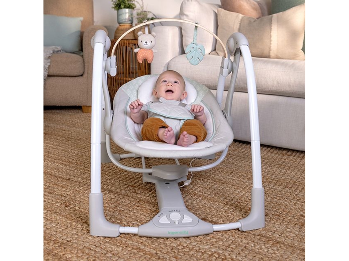 Columpio portátil para bebé Ingenuity Cozy Spot con arco de actividades y música.