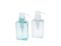 Botellas de plástico azul y transparente de 100 ml con dosificador para champú y gel de ducha reutilizable.