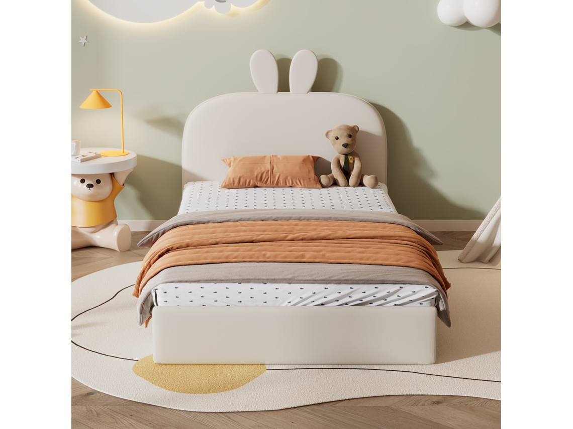 Cama infantil de 90 x 200 cm acolchada en terciopelo con cabecero en forma de conejo y somier de láminas en color beige.