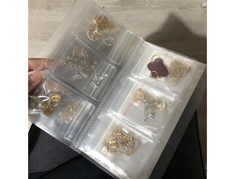 Libro de almacenamiento de joyas transparente OWSEN, libro organizador de pendientes, almacenamiento de joyas anti oxidación (84 rejillas + 50 piez...