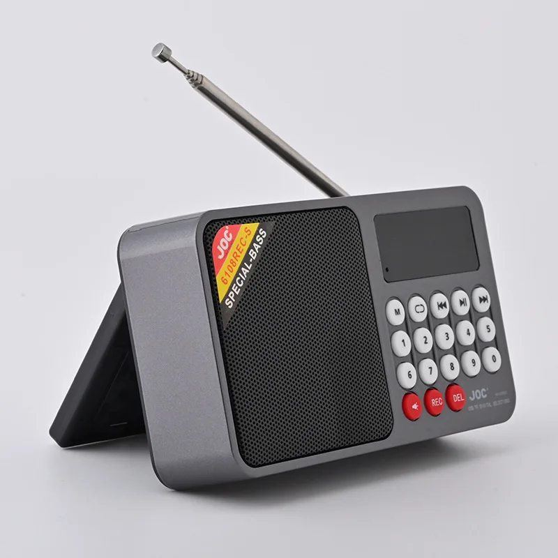 Radio de emergencia mini (gris) con pantalla LED, alimentada por energía solar, altavoz y grabadora Bluetooth, compatible con tarjeta TF e interfaz USB.