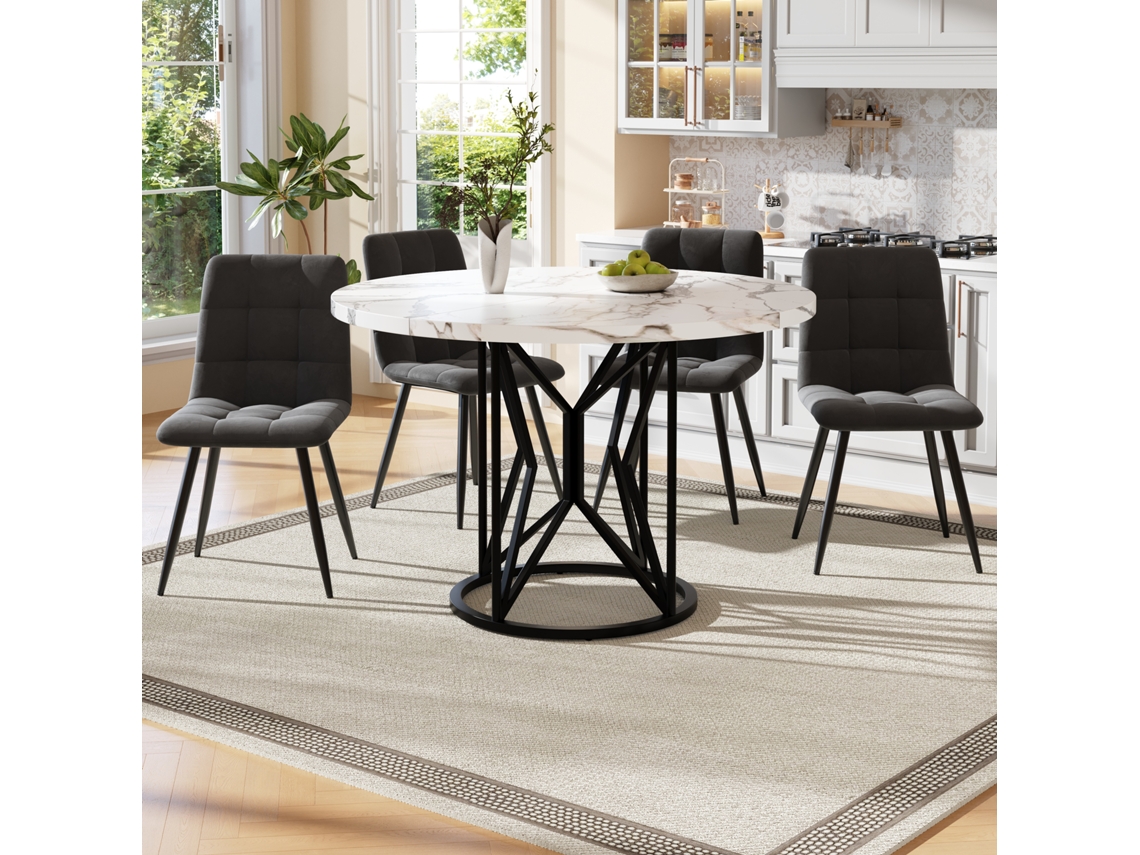 Mesa de comedor redonda de 100x100x76 cm y 4 sillas. Tablero de MDF, estructura de metal y cojines de terciopelo blanco y negro.